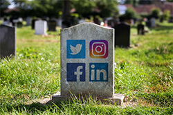 Social media icons on a tombstone.