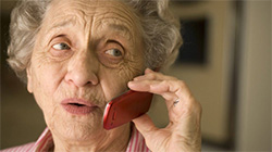 A senior woman talks on a cellular phone.