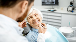 A senior woman received a dental exam.