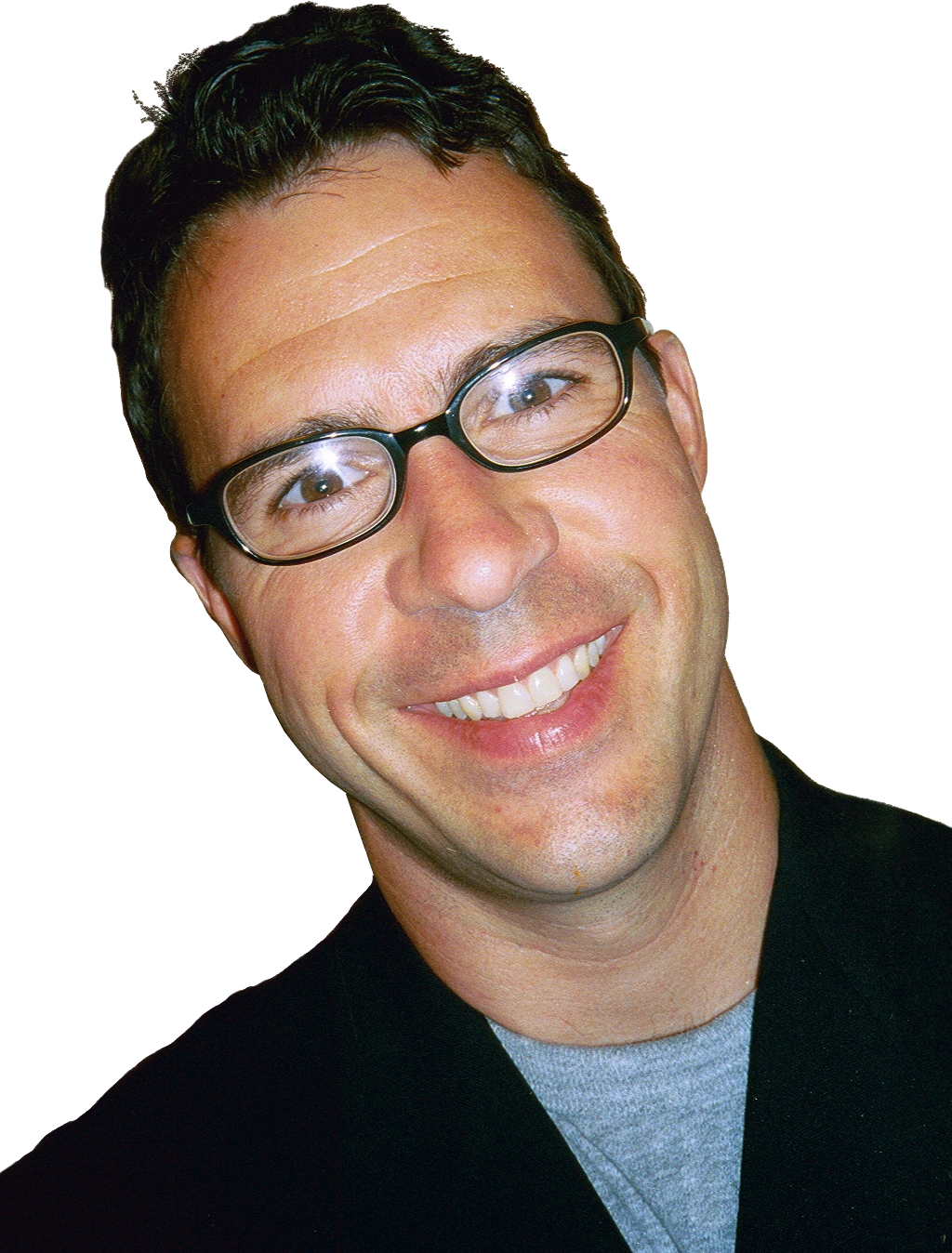 A man with glasses smiling for the camera.